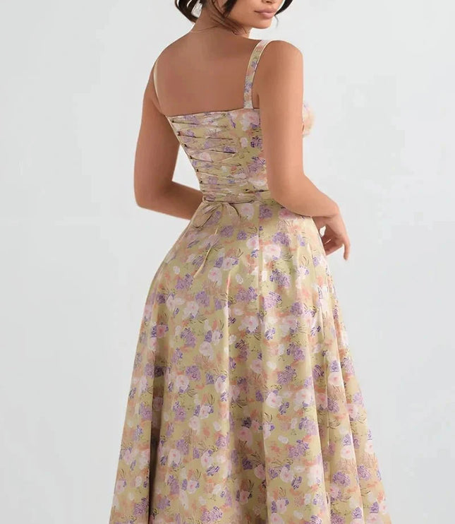 Back view of yellow floral midi dress with open back, straps, and gathered waist