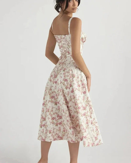 Back view of white floral midi dress with pink flowers, straps, and flared midi skirt