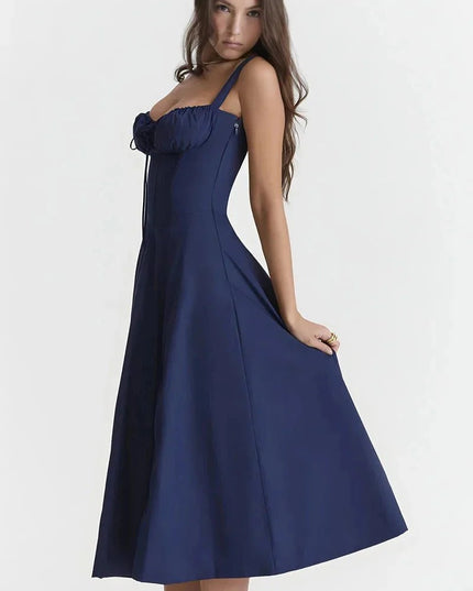 Side view of navy blue midi dress with fitted bodice and flowing A-line skirt