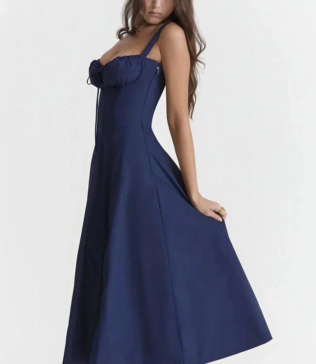 Side view of navy blue midi dress with fitted bodice and flowing A-line skirt