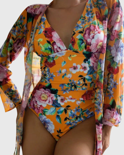 Orange floral one-piece swimsuit with long-sleeve wrap, vibrant botanical design