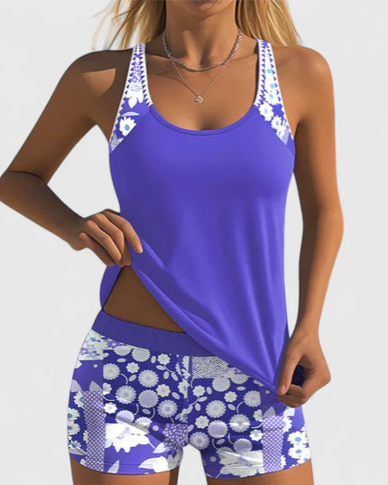 Royal blue tankini with white floral straps and daisy shorts front view