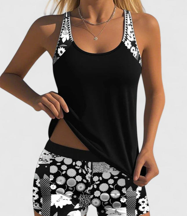 Black tankini with white daisy print straps and shorts front view