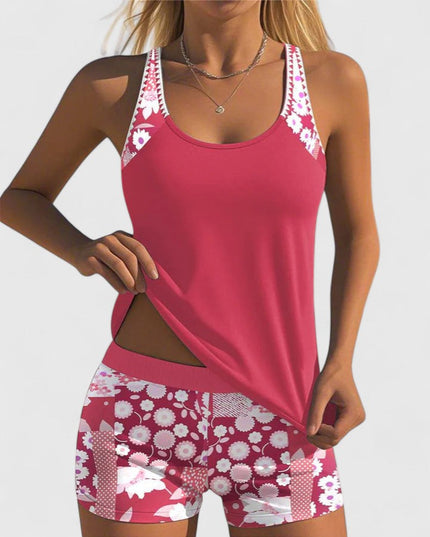 pink tankini with white floral print straps and shorts front view