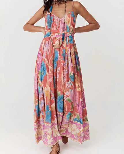 Full-length front view of a women's floral print V-neck maxi sundress, cinched at the waist, with a detailed floral hem.