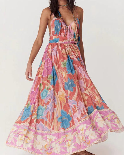 Side view of a women's floral print V-neck maxi sundress with a flowing skirt, showcasing the vibrant floral design.