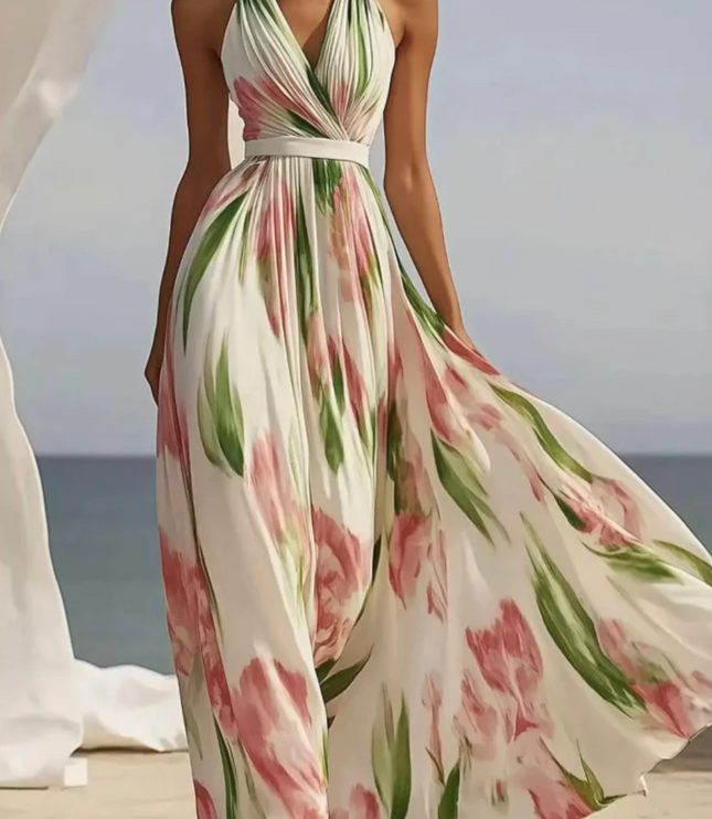 Cream floral halter maxi dress with pink and green print, fitted waist and full flowing skirt