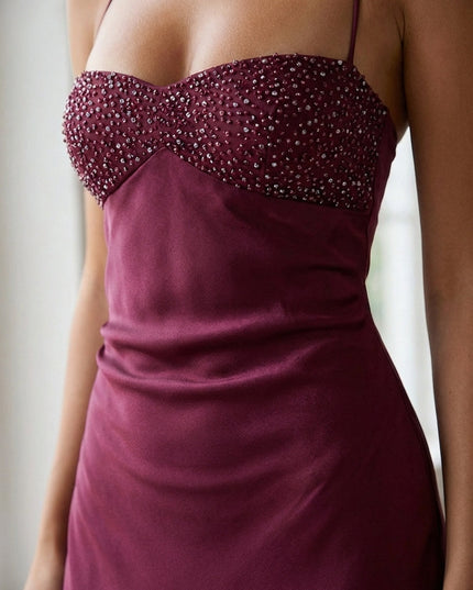 Close-up of burgundy beaded sweetheart bodice with crystal embellishments