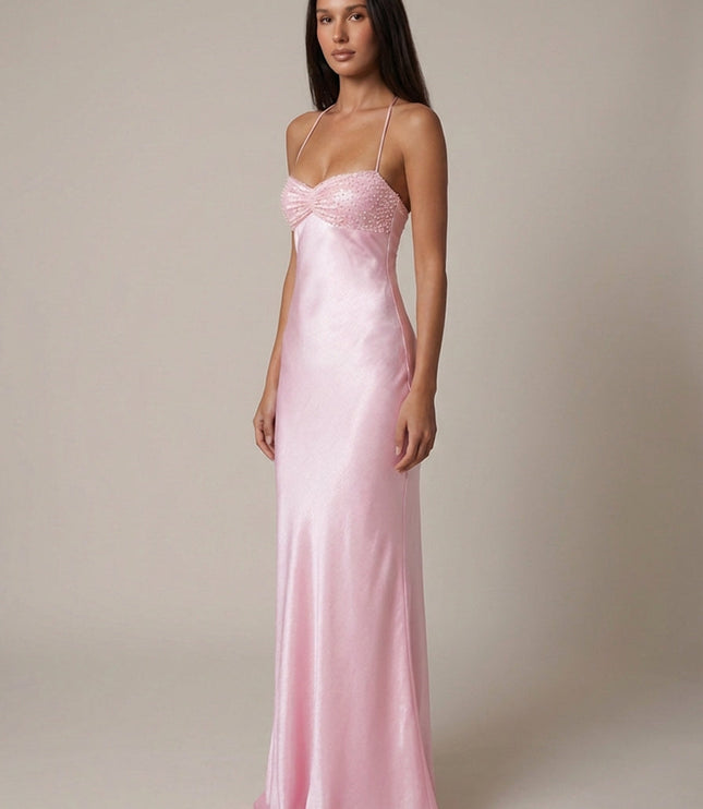 Side view of pink formal halter maxi dress with beaded bodice