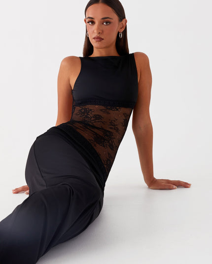 Black formal maxi dress with lace waist detail in seated pose