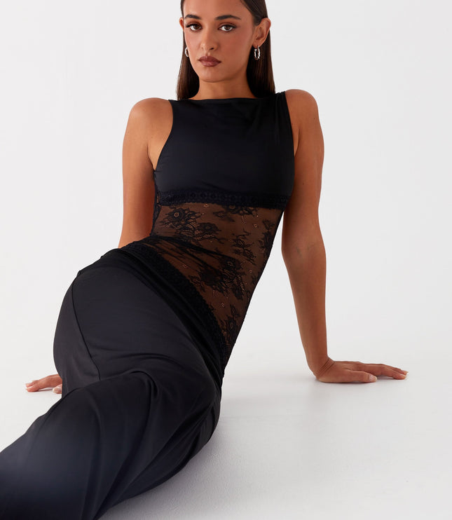 Black formal maxi dress with lace waist detail in seated pose