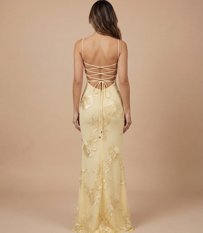 Back view of a pale yellow floral V neck maxi dress with crisscross lace-up back