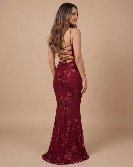 Back view of burgundy floral maxi dress with crisscross lace-up back and flowing hem