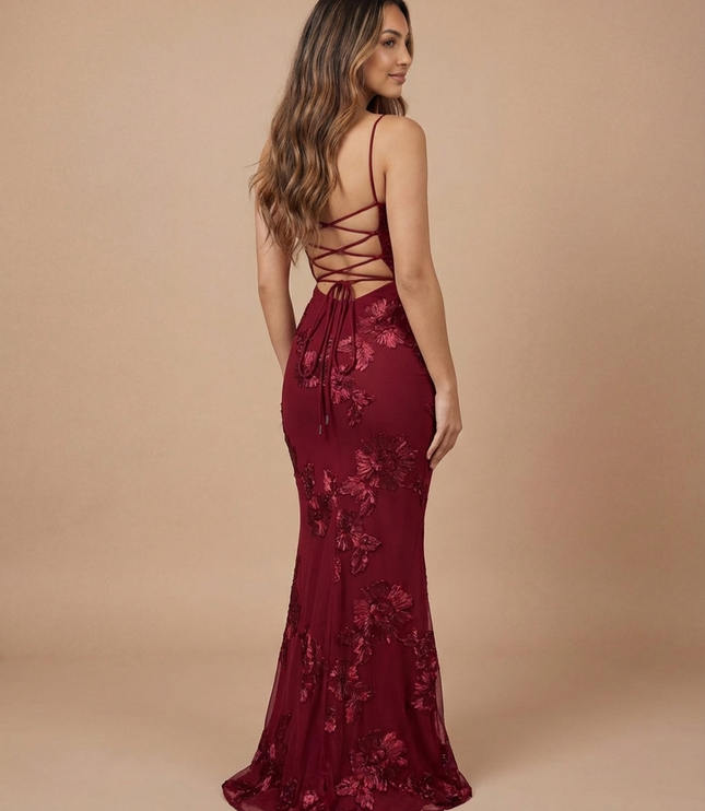 Back view of burgundy floral maxi dress with crisscross lace-up back and flowing hem