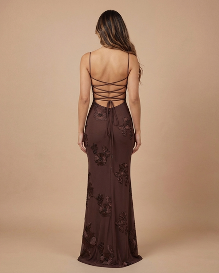 Back view of brown floral maxi dress with lace-up open back and sheer floor-length skirt