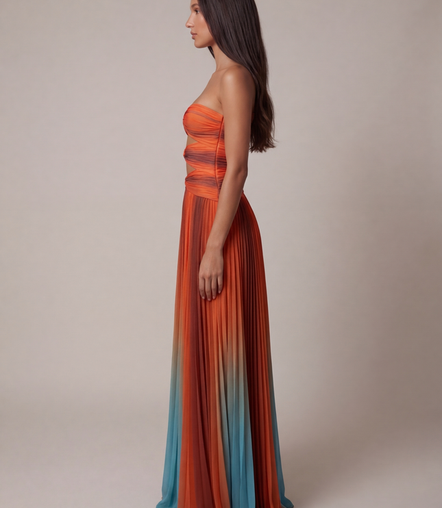 Side view of strapless ombre maxi dress with ruched bodice and flowing pleated skirt