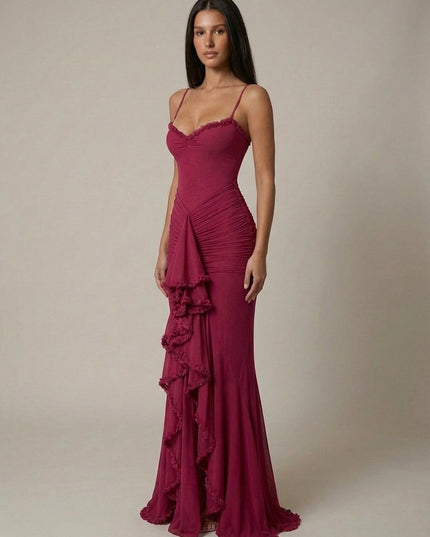 Front view of magenta maxi dress with fitted bodice, ruched skirt, and ruffle detail