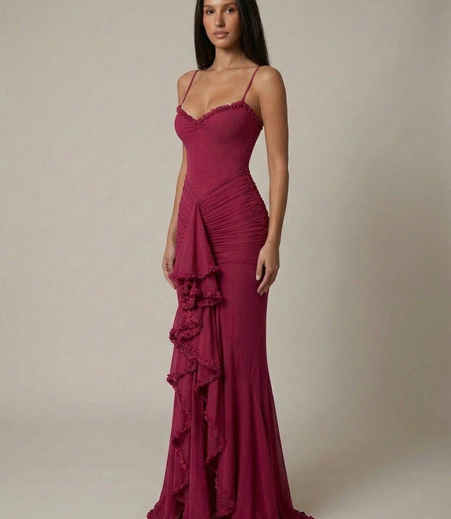 Front view of magenta maxi dress with fitted bodice, ruched skirt, and ruffle detail