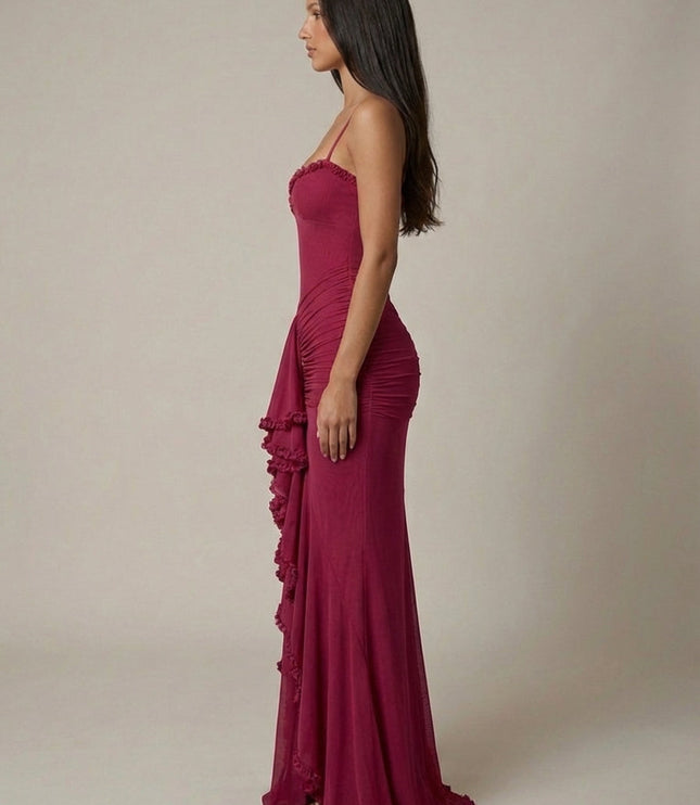 Side view of magenta cocktail maxi dress showing fit, spaghetti straps, and ruffled front panel