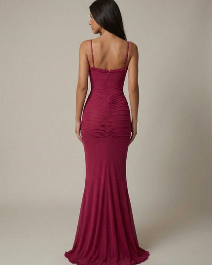Back view of magenta maxi dress with ruched back, spaghetti straps, and floor-length hem