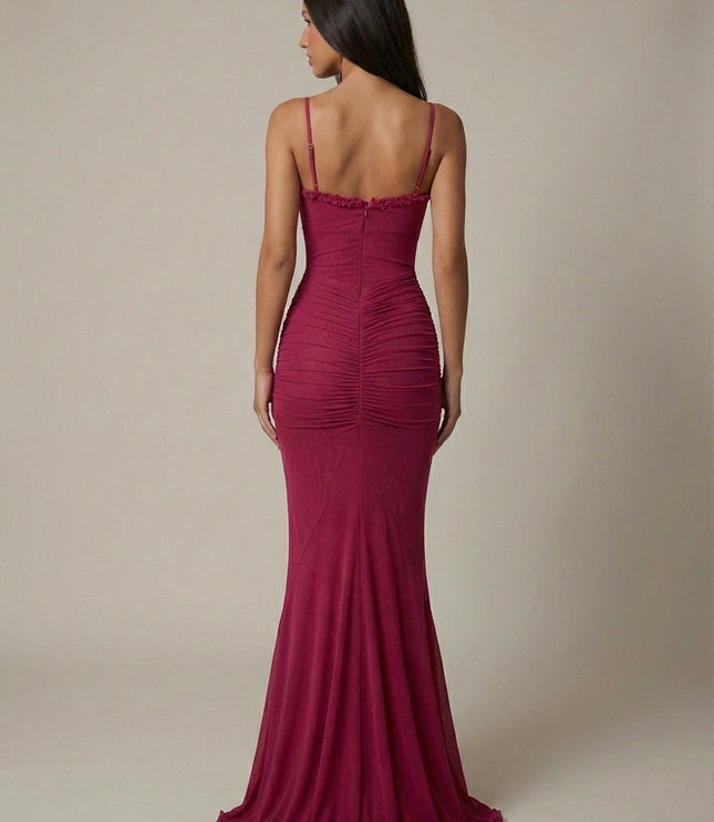 Back view of magenta maxi dress with ruched back, spaghetti straps, and floor-length hem