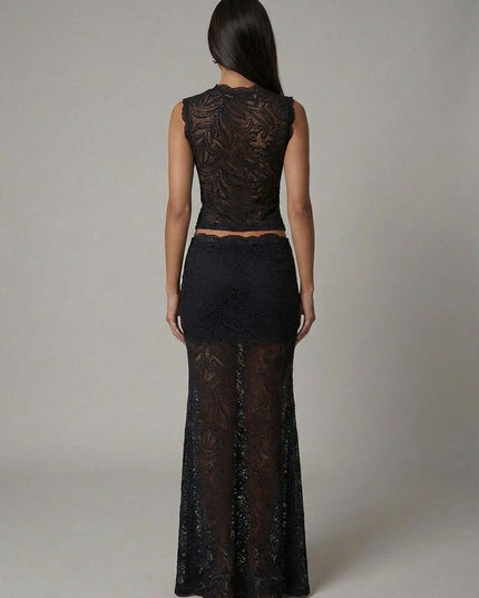 Back view of black lace formal set showing cropped top and flowing maxi skirt