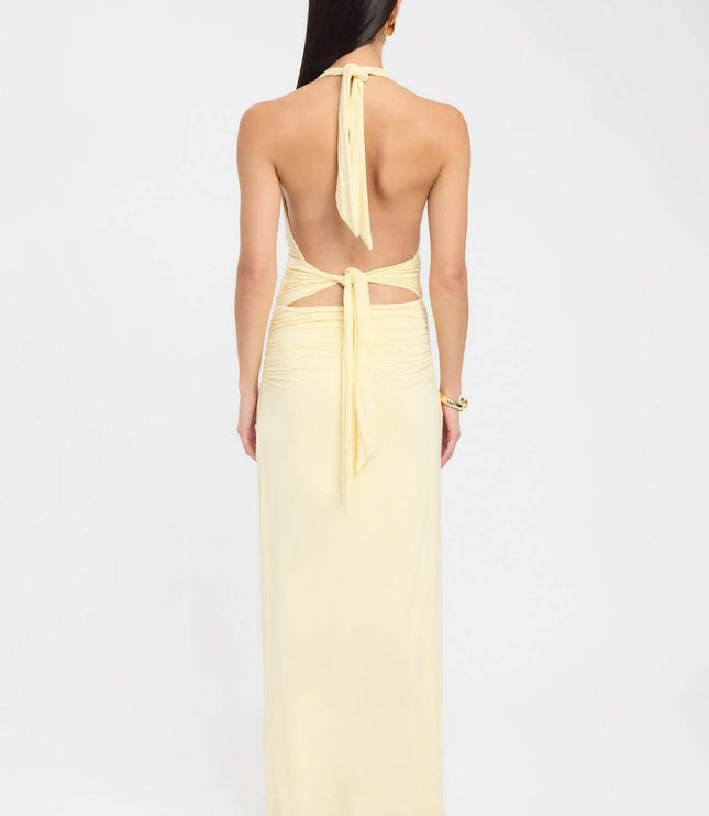 Back view of pale yellow formal maxi halter dress with open back and tie waist