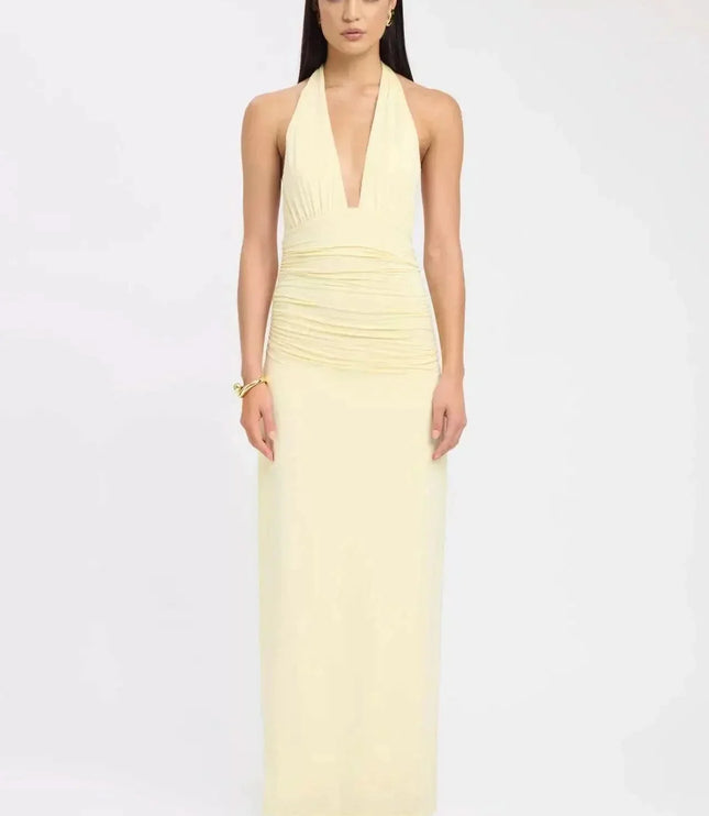 Back view of black formal maxi halter dress with open back and draped tie detail