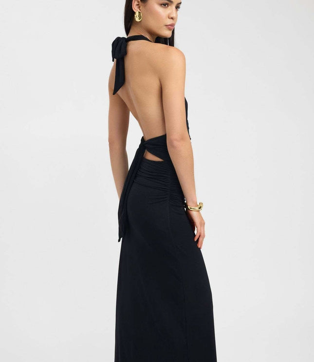 Back view of black formal maxi halter dress with low open back and long tie sash