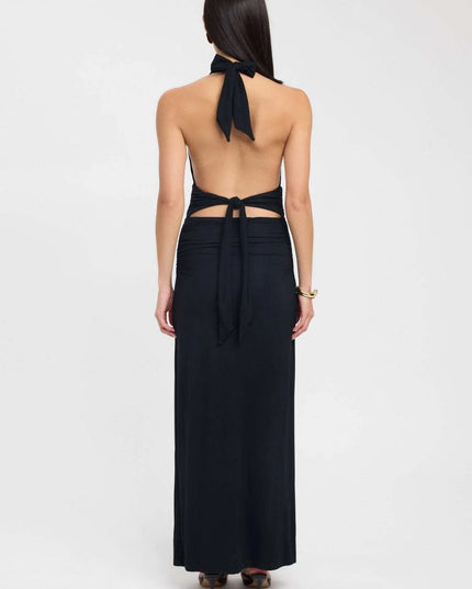 Side view of a pale yellow halter maxi dress with open back and gathered waist