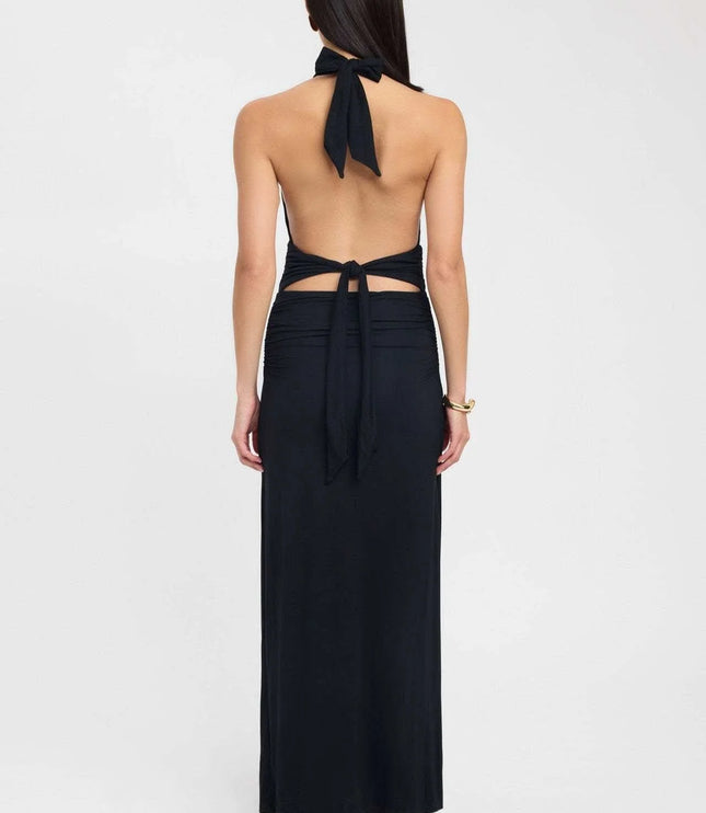 Side view of a pale yellow halter maxi dress with open back and gathered waist