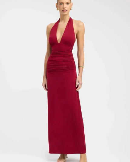Back view of a black halter maxi dress with open back, tie neck, and tie waist