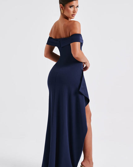 Side back view of navy formal maxi dress showing draped skirt and slit detail