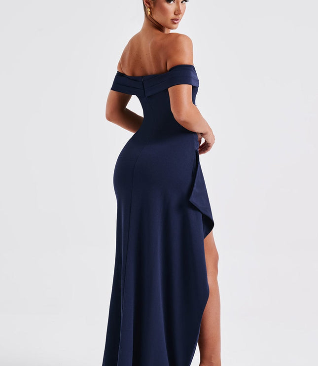 Side back view of navy formal maxi dress showing draped skirt and slit detail