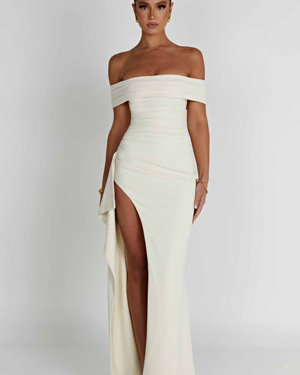 Front view of cream off shoulder formal maxi dress with fitted waist and slit