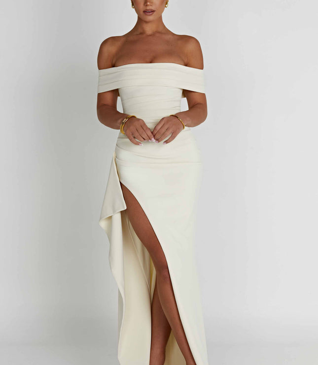 Cream off shoulder maxi dress with high slit and flowing skirt, angled front view