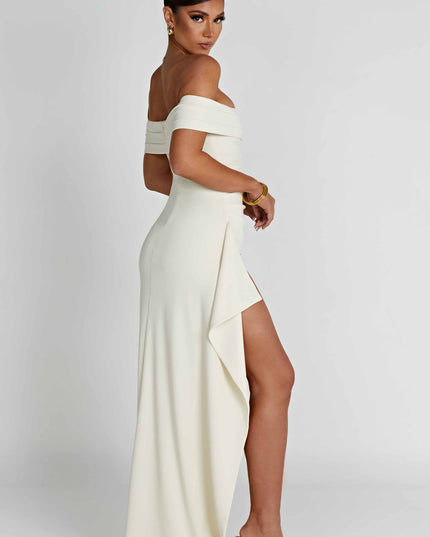 Back side view of cream off shoulder maxi dress with long flowing skirt and slit