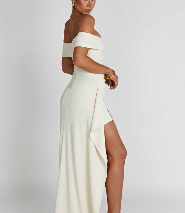 Back side view of cream off shoulder maxi dress with long flowing skirt and slit