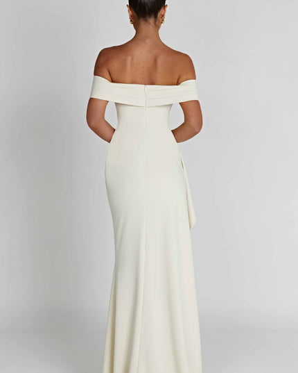 Back view of ivory off shoulder maxi dress with fitted bodice and floor length skirt