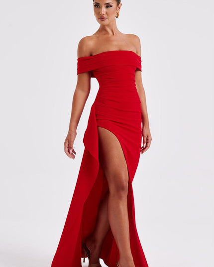 Back view of red off shoulder maxi dress with open neckline, fitted back, and long train
