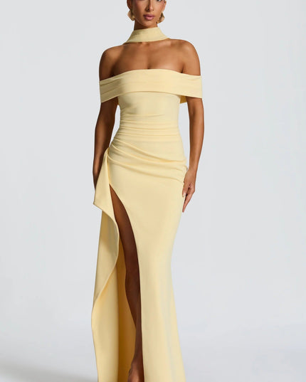 Front view of pale yellow off shoulder maxi dress with high slit and fitted formal silhouette
