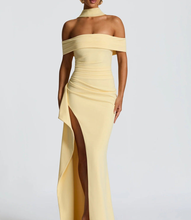 Front view of pale yellow off shoulder maxi dress with high slit and fitted formal silhouette