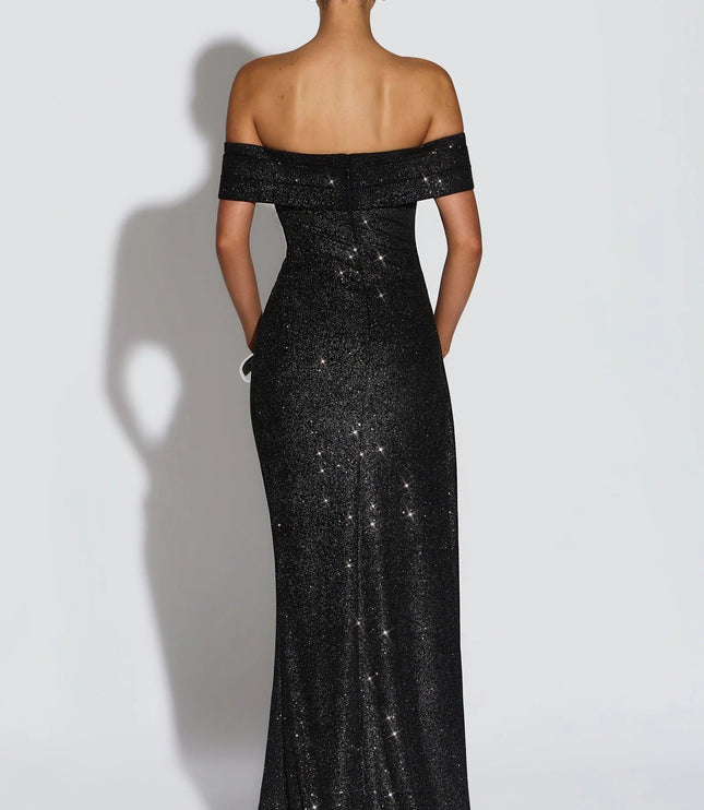 Back view of black off shoulder maxi dress with glitter finish and fitted silhouette