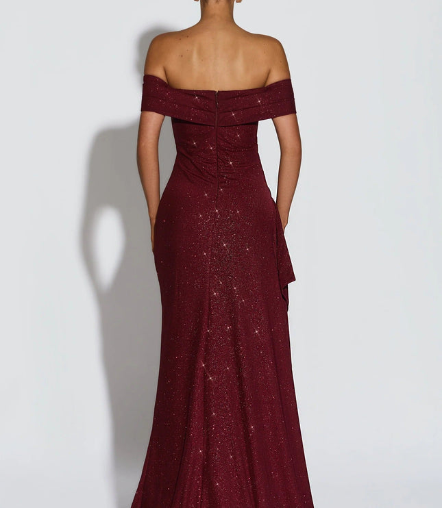 Close front view of burgundy off shoulder maxi dress with ruched bodice and side slit