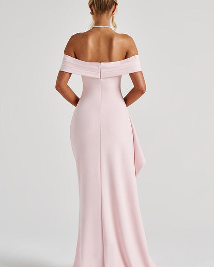 Three-quarter view of pale pink formal dress with off shoulder neckline and high leg slit
