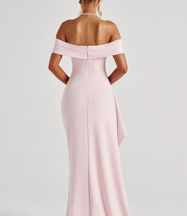 Three-quarter view of pale pink formal dress with off shoulder neckline and high leg slit