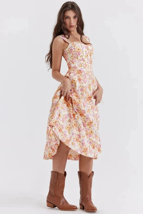 Side view of floral midi dress with fitted bodice, slit hem, and off shoulder straps