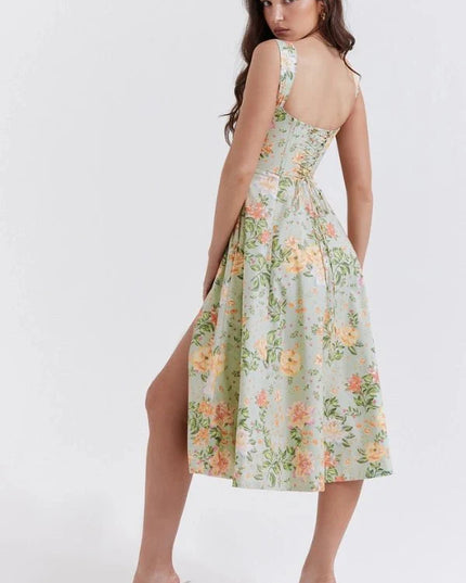 Back view of green floral midi dress with fitted waist and open back design