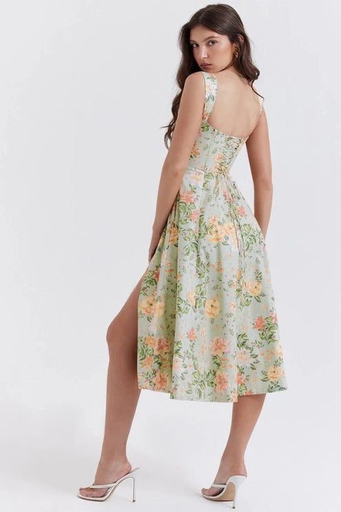 Back view of green floral midi dress with fitted waist and open back design