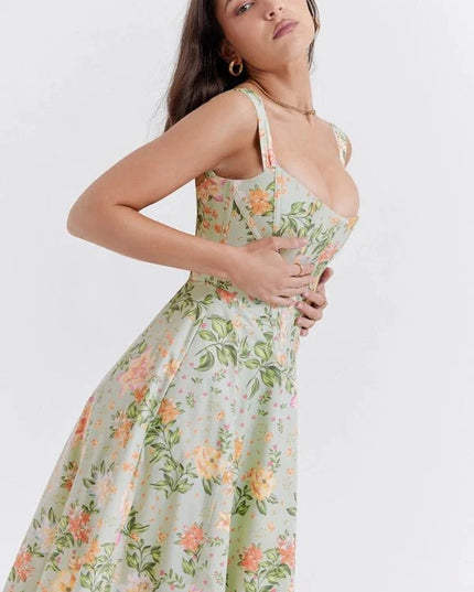 Side view of green floral off shoulder midi dress with corset bodice and flowing skirt